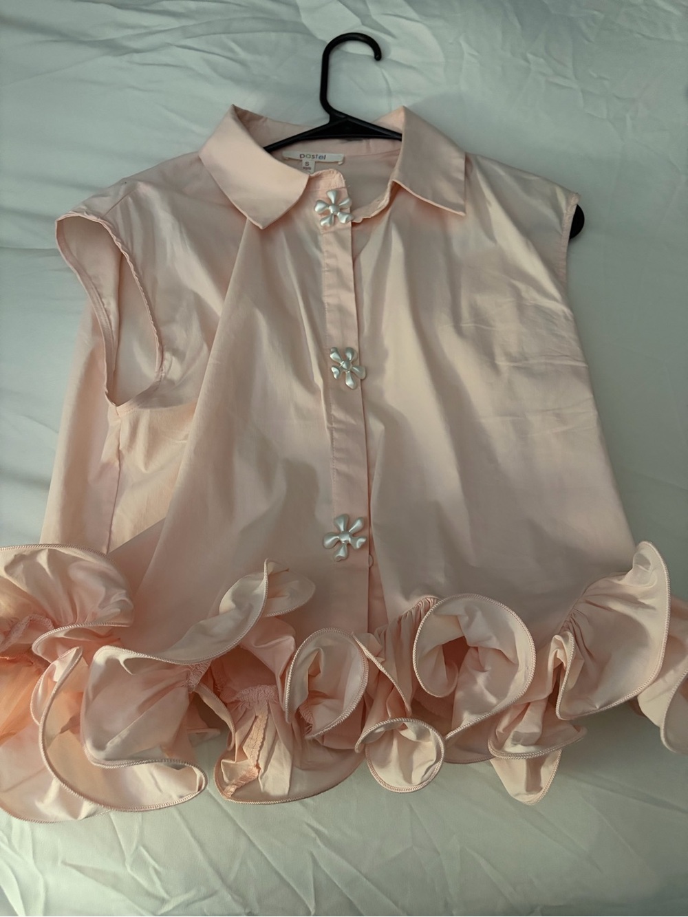 Sleeveless Pale Peach Ruffle-Hem Blouse with Floral Buttons